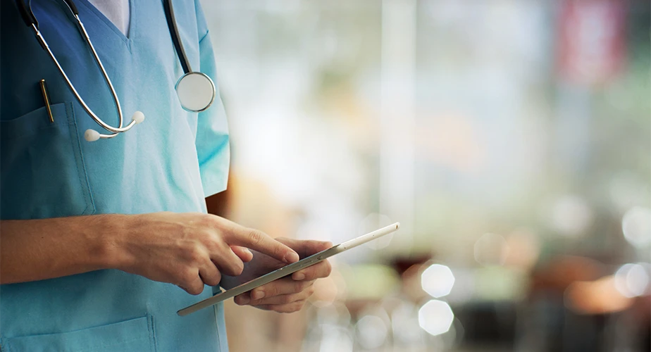 Close-up of a doctor with a tablet in hands (Photo)